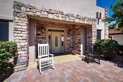 Entrance of a senior living facility with rocking chairs
