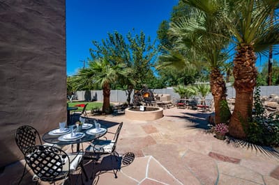 Outdoor patio area with seating and palm trees