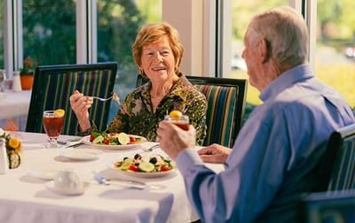 Residents enjoying a meal in the dining room