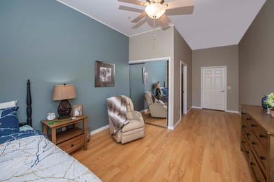 Cozy resident room with wood floor and seating area