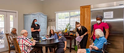Residents engaging in group activities at a dining table