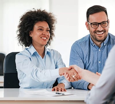 Avamere Rehabilitation of Lebanon, Nursing Home in Lebanon, OR — Two people shaking hands in a meeting room