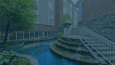 Bethel Health Care Center, Nursing Home in North Newton, KS — Serene water feature with stone steps and greenery
