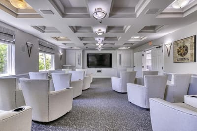 Bright common area with plush seating and TV
