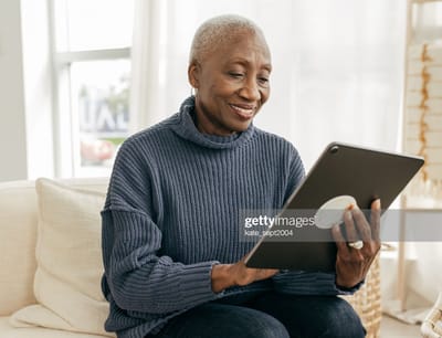 Bethel Health Care Center, Nursing Home in North Newton, KS — Senior woman using a tablet in a cozy setting