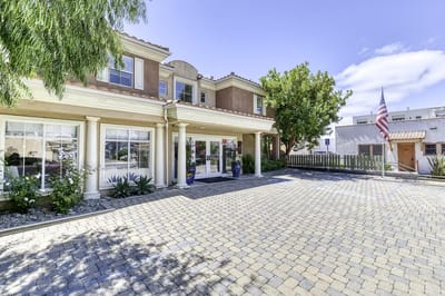 Front entrance of a senior living facility with landscaped area