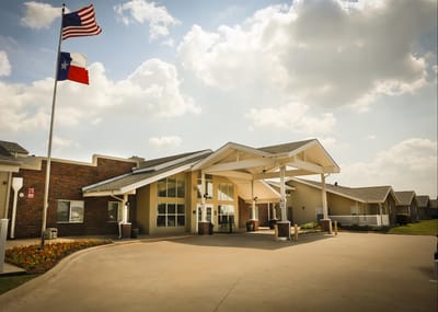 Building exterior with flags outside a senior living facility