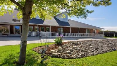 Exterior view of a senior living facility with garden