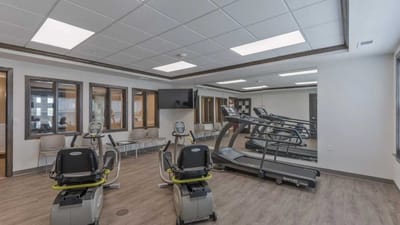 Cedar Ridge Village, nursing home in West Des Moines, IA — Exercise equipment in a well-lit fitness room