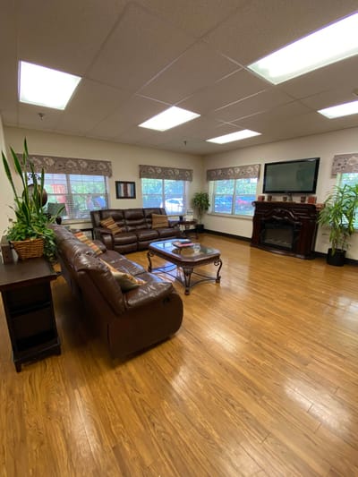 Cozy common area with leather furniture and plants