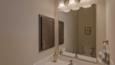 Cedar Ridge Village, nursing home in West Des Moines, IA — Bathroom with a mirror, sink, and towel rack