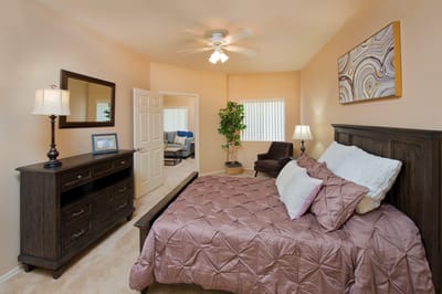 Cozy bedroom with brown decor and a ceiling fan