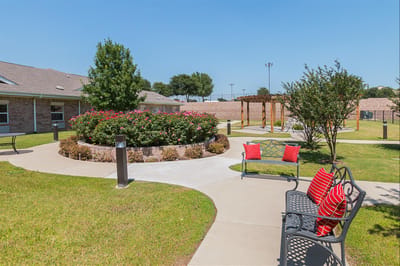A landscaped outdoor space with benches and flowers