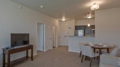 Cedar Ridge Village, nursing home in West Des Moines, IA — Minimalist living room and kitchen interior with dining table