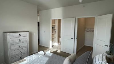 Cedar Ridge Village, nursing home in West Des Moines, IA — Brightly lit bedroom with open doors and dresser