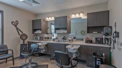 Cedar Ridge Village, nursing home in West Des Moines, IA — Hair salon interior with styling chairs and equipment