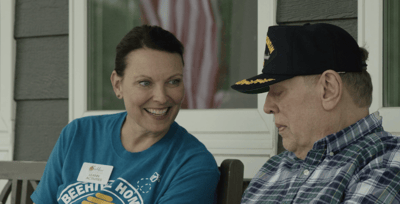 A staff member engaging with a resident outdoors