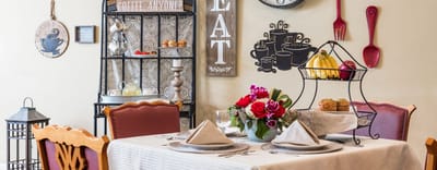 A beautifully set dining table in a warm interior space