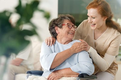 Caregiver and resident sharing a joyful moment indoors