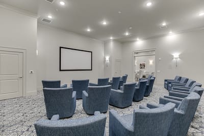 Interior activity room with seating and screen