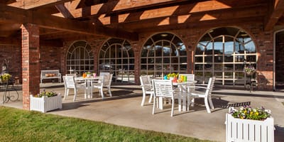 Outdoor seating area with tables and flowers