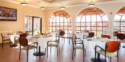 Bright dining room with tables set for meals