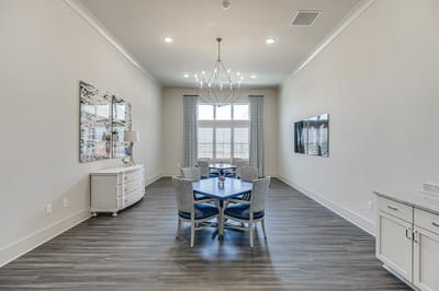 Bright, modern common area with dining table and chairs