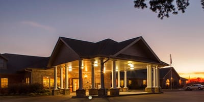Exterior view of Bradford House Nursing and Rehabilitation at sunset