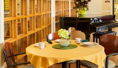 Interior dining area with table and piano