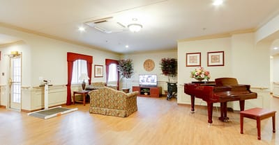 Interior view of a common area with seating and piano