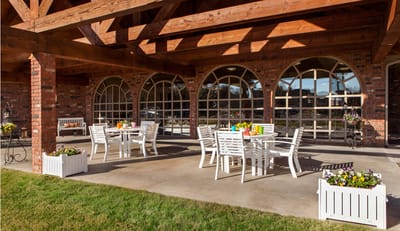Outdoor seating area with tables and flowers