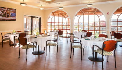 Bright dining room with tables set for a meal