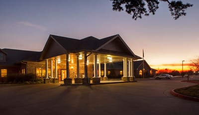 Exterior view of Bradford House Nursing and Rehabilitation at sunset