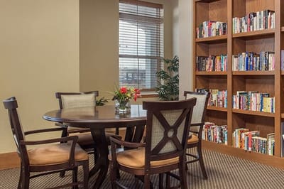 Cozy reading area with a table and bookshelves