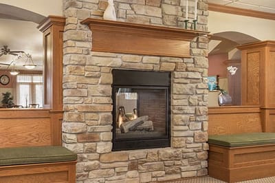 Cozy common area with a stone fireplace and seating