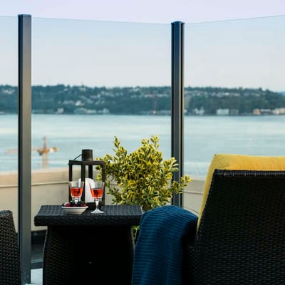 Outdoor seating area with drinks overlooking the water