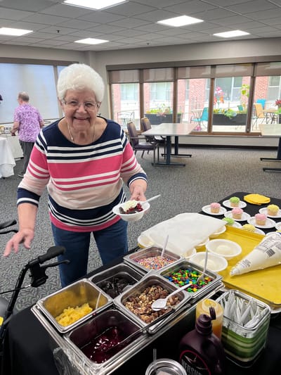 A resident enjoying dessert at a community activity