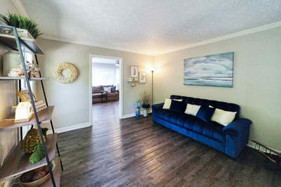 Cozy lounge area with blue sofa and wall decor