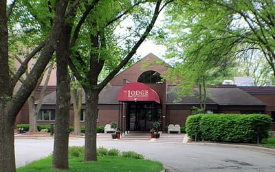 Entrance view of the lodge with greenery