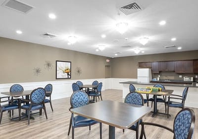 Bright common area with tables and chairs for activities
