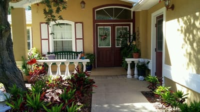 Entrance to Good Sam's Assisted Living Residence with flowers