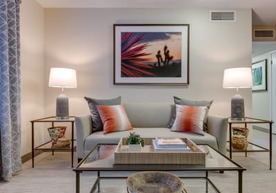 A cozy common area with a sofa and lamps