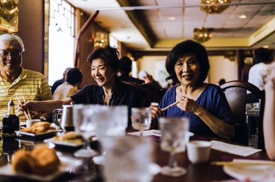 Residents enjoying a meal together at a dining table