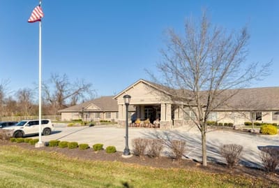 Exterior view of Cedar Creek of Bloomington facility with flag