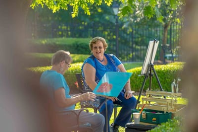 Residents painting together in an outdoor space