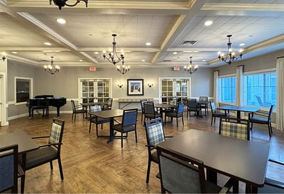 Common area with dining tables and a piano