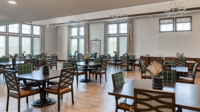 Dining area with tables and chairs in a bright setting
