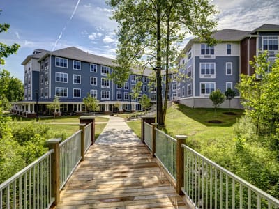 Exterior view of Evergreen Village at Bloomington with a pathway