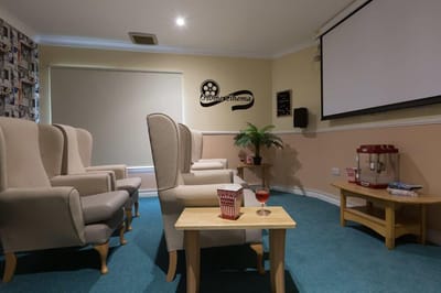 Interior of a cozy movie room with seating and snacks