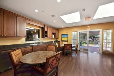 Bright common area with seating and kitchen access
